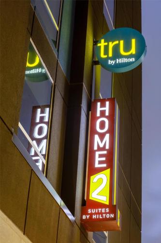 two signs on the side of a building at Home2 Suites By Hilton Houston Downtown Convention Center in Houston