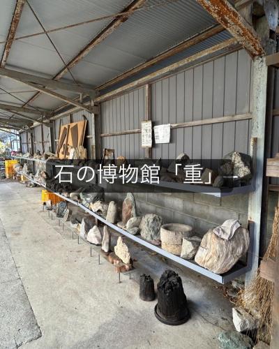 a row of shelves in a building with rocks at Rom's Inn in Wakimachi