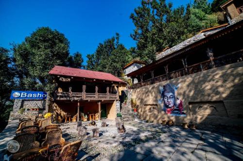 a building with a painting on the side of it at Basho Mud Huts in Vashisht