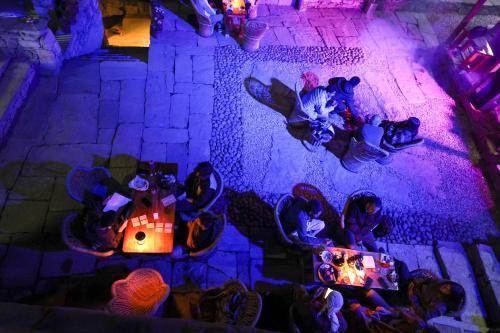 an overhead view of a group of people sitting around a table at Basho Mud Huts in Vashisht