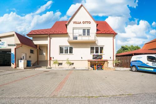 a building with a sign on the side of it at Villa Otto in Dunajská Streda