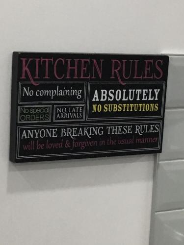 a sign on the wall of a bathroom at Almost Heaven - Cozy 2BDRM APT near Heritage Park,Spruce Meadows & Banff-SW Calgary in Calgary