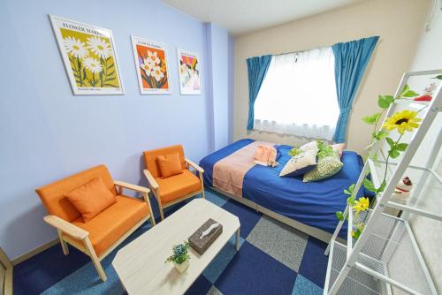 a small room with a bed and chairs and a ladder at AO303 - Tokyo Stay Spacious Apartment Direct Train to Narita & Asakusa in Tokyo