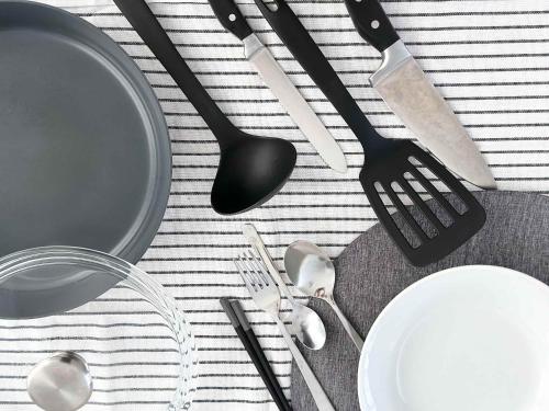 a table with utensils and plates and forks and spoons at Spacious Traditional Japanese house by Restavio in Ozu