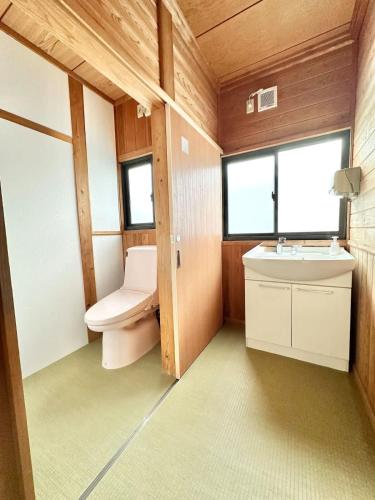 a bathroom with a toilet and a sink at Spacious Traditional Japanese house by Restavio in Ozu