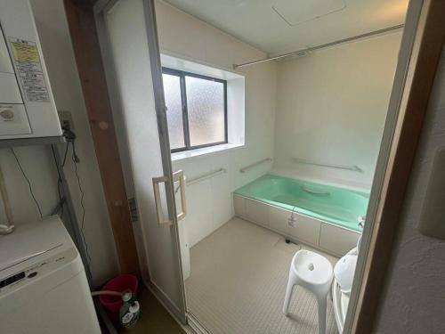 a small bathroom with a sink and a glass shower at Spacious Traditional Japanese house by Restavio in Ozu