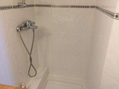 a shower with a shower head in a bathroom at Chez Nahiko STUDIO Paris Massy Palaiseau in Palaiseau