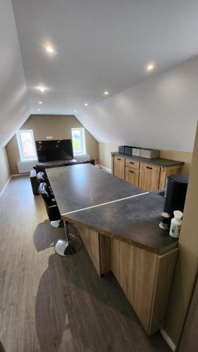 a large kitchen with a large wooden counter top at Appartement à Gravelines in Gravelines