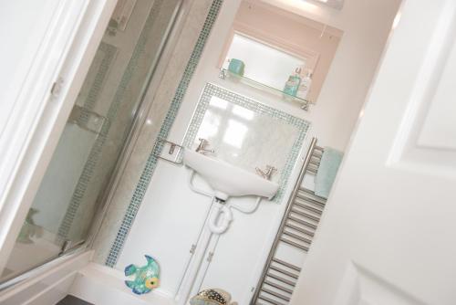 a bathroom with a sink and a mirror at The School House in Bridgwater