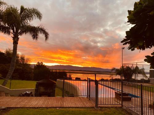 a view of a sunset from the deck of a house at Peninsula Paradise in Tauranga
