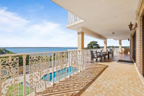 an outdoor balcony with a view of the water at Waterfront Wonder in Dawesville in Dawesville