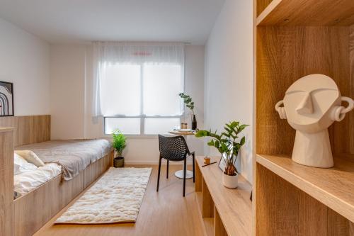 a small bedroom with a bed and a window at Sweetly Saclay Gif-sur-Yvette in Gif-sur-Yvette
