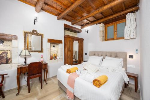 a bedroom with a bed and a desk and a mirror at Villa Anta in Astérion