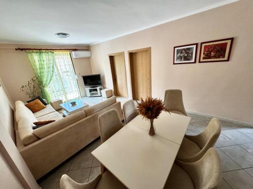 a living room with a couch and a table at Large apartment in Golem in Golem