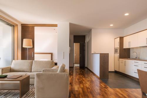 a living room with a couch and a table at Appartement KroneLiving in Tirolo