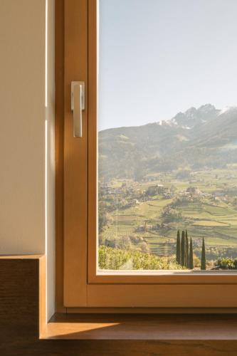 a window with a view of a mountain view at Appartement KroneLiving in Tirolo