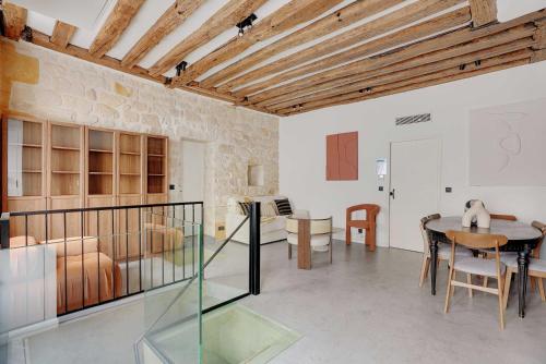 un salon avec une table et une salle à manger dans l'établissement Spacious apartment - 4BR-10P - Place des Vosges, à Paris