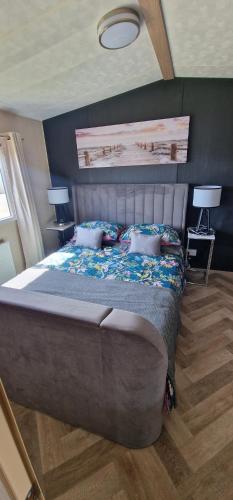 a bedroom with a large bed with two pillows at The Beach House East Mersea in Mersea Island