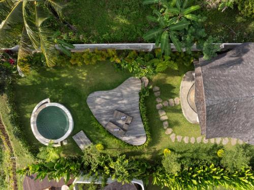 an overhead view of a garden with a bench at Damuh Alam in Lovina