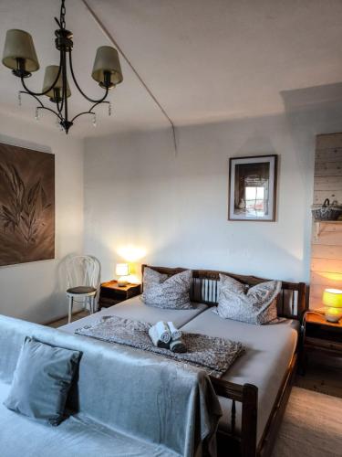 a bedroom with two beds and a chandelier at Nerezine centrum _ apartmán pro 2 osoby in Nerezine