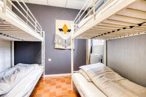 two beds in a room with two bunk beds at Arden Parks Signy l'Abbaye in Signy-lʼAbbaye