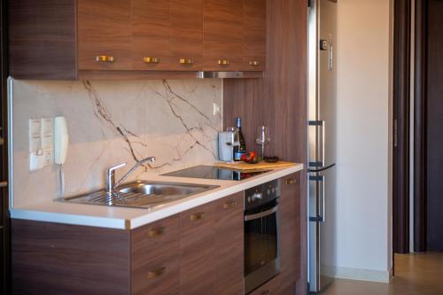 a kitchen with a sink and a refrigerator at Ikosapartments -home 3-4 in Perdika