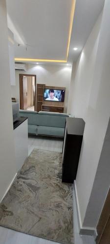 a living room with a tv on a wall at Hurghada Mirage Bay Hotel & Aquapark in Hurghada