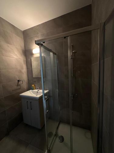 a bathroom with a shower and a sink at Oroklini's Flat in Larnaka