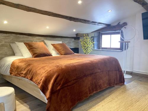 a bedroom with a large bed and a window at Escapade Romantique & Balnéo in Riom