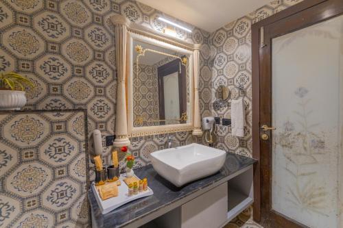 a bathroom with a sink and a mirror at Clarks Resort The Archi`s Castle, Ajmer in Ajmer