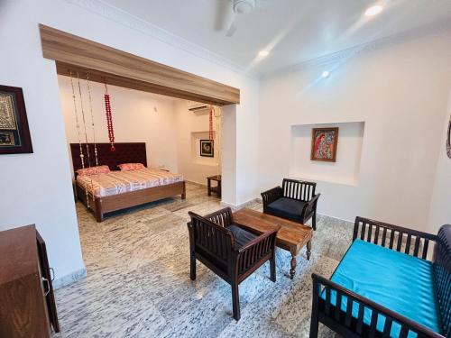 a living room with a bed and a couch at Phulkari Hospitality Dhanbad in Dhanbād