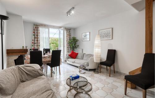 a living room with a couch and a table at 3 Bedroom Awesome Home In Lagord in Lagord