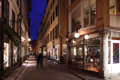 a person walking down a street at night at Lord Nelson Hotel in Stockholm