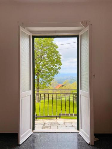 an open door to a balcony with a view at Casa Mariuccia in Ponzone