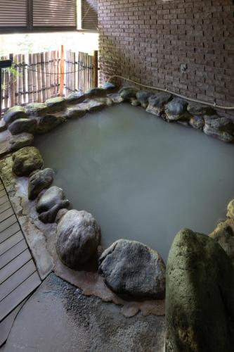 a pool of water next to a brick wall at シーザー強羅クラブ箱根 Caesar Gora in Gora