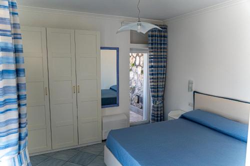 a bedroom with a bed and a window at La Tranquilla Apartment in Capri