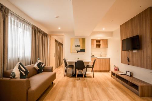 a living room with a couch and a table at Snooze Inn & Suites in Davao City