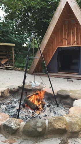 a fire in front of a building with a tent at Granngården in Fåborg