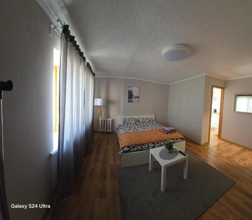 a bedroom with a bed and a table in it at Sea side apartments in Jūrmala