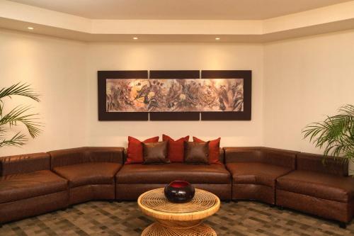 a living room with a brown couch and a table at Casa del Alma Hotel Boutique & Spa in San Cristóbal de Las Casas