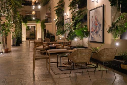 a lobby with chairs and tables and plants at Casa del Alma Hotel Boutique & Spa in San Cristóbal de Las Casas