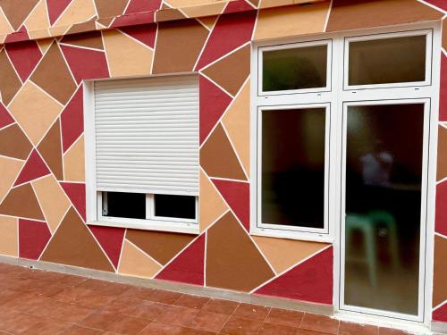 two windows on the side of a building at Hostel VAM Torrejón in Torrejón de Ardoz