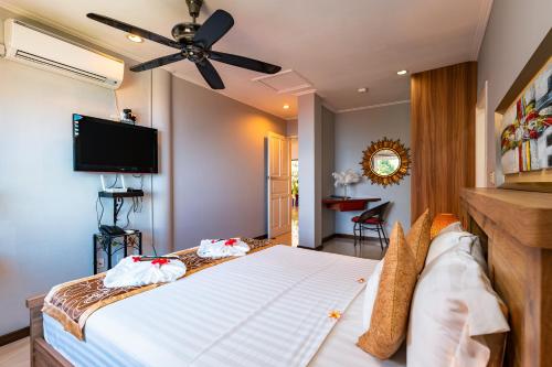 a bedroom with a bed with a ceiling fan at Glacis Heights Villa in Glacis