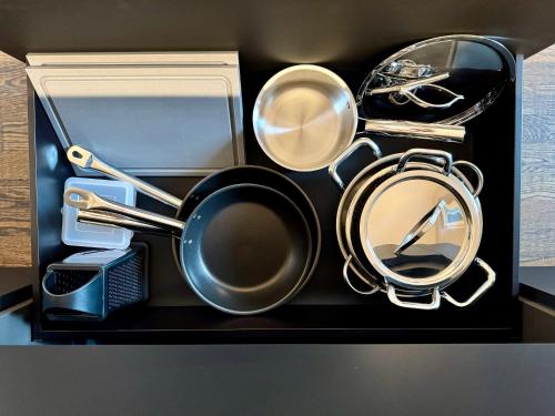 a box with a pot and pans and a mirror at VILLAREJA - Stilvolle ruhige Boutique-Suite mit Terrasse, Designbad und Altstadtblick im Herzen von Bozen in Bolzano