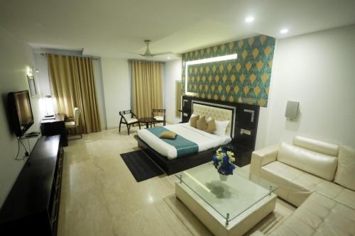 a living room with a bed and a couch at Shanti Sewa Dham in Chhatikara