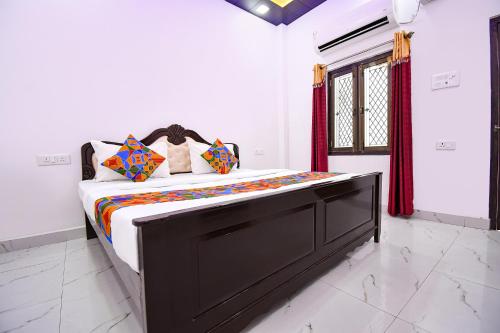 a bedroom with a large bed in a room at FabHotel Geeta Bhawan in Ayodhya