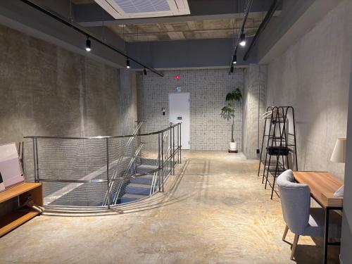a hallway with a staircase in a room at Hotel art rock in Takamatsu