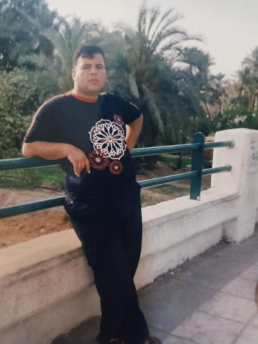a man is standing next to a railing at Dana Village experience hotel in Dana
