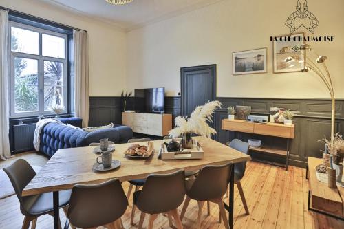 un salon avec une table et des chaises dans l'établissement Capucine - Haussmannien de Charme - 50m plage, à Les Sables-dʼOlonne