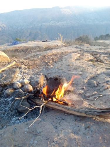 a fire on the ground on top of a mountain at Dana Village experience hotel in Dana